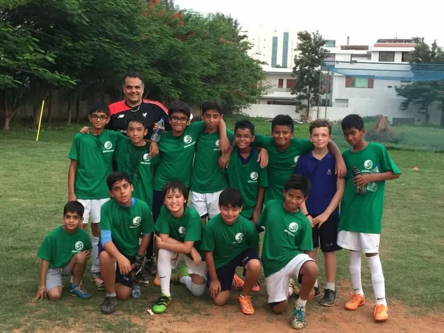 Jay's childhood football team with their coach